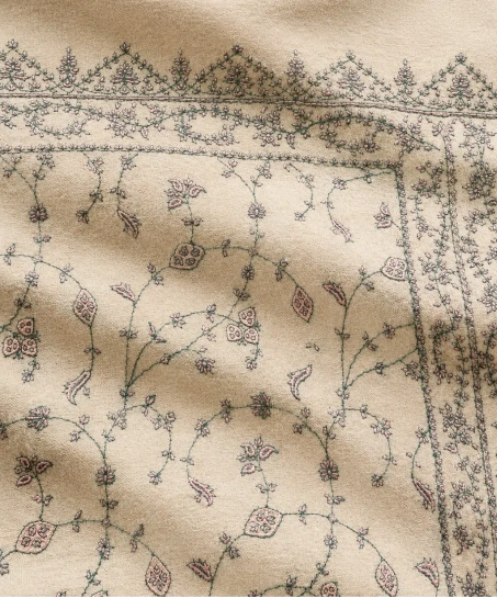 Close-up of the handcrafted Kashmiri shawl featuring elegant floral vine embroidery, decorative border patterns, and premium artisan craftsmanship.