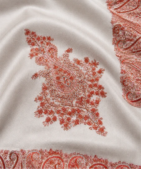 Close-up of the handcrafted Kashmiri shawl featuring intricate paisley embroidery, floral corner detailing, and smooth, luxurious woven fabric.
