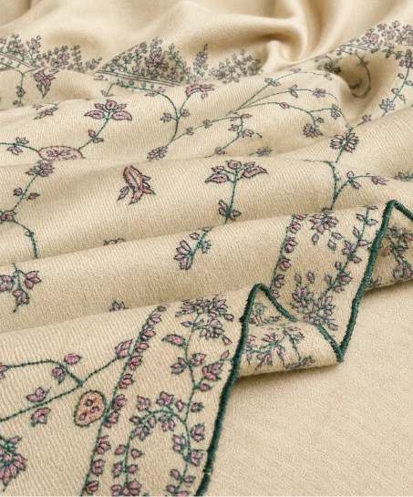 Close-up of the handcrafted Kashmiri shawl highlighting intricate floral vine embroidery, decorative blue border detailing, and the soft woven texture.
