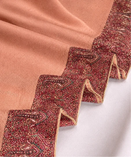 Close-up of the handcrafted Kashmiri shawl highlighting intricate paisley and floral embroidery, decorative border detailing, and the smooth woven texture.
