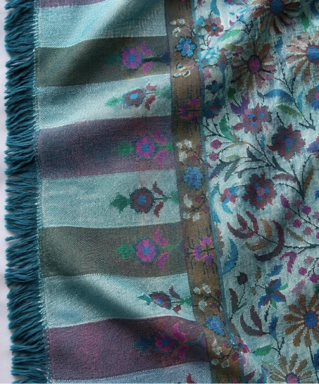 Detailed view of the Kashmiri shawl showcasing multicolor woven borders, floral patterns, smooth fabric, and finely finished tasseled fringes.
