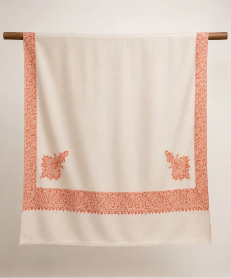 Handcrafted Kashmiri embroidered shawl displayed flat, featuring an ivory body with ornate paisley embroidered borders, floral corner motifs, and finely finished fringed edges.